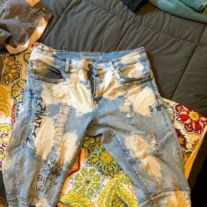 Jeans Size 32 Color Blue and white with graphic designs on them